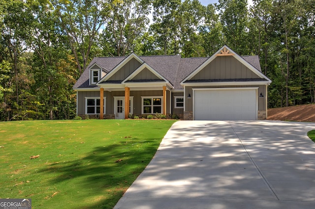 craftsman-style house featuring a garage and a front lawn