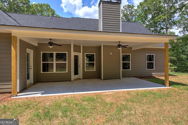 rear view of house featuring a yard, ceiling fan, and a patio