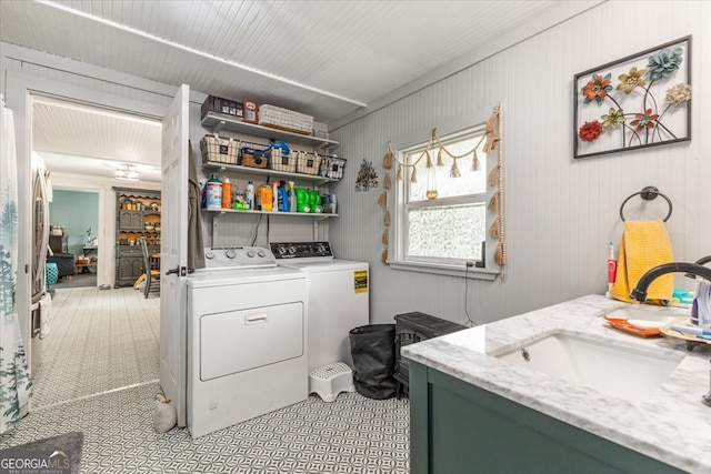 laundry room featuring washing machine and clothes dryer and sink