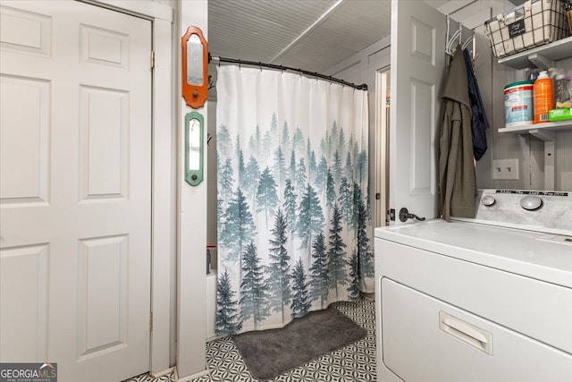 bathroom with vanity, shower / bath combo, and washer / clothes dryer