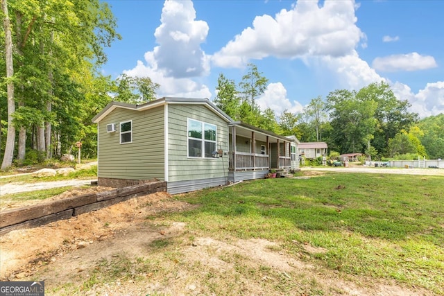 view of property exterior featuring a yard and a porch