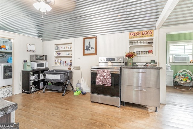 kitchen with stainless steel electric stove, light hardwood / wood-style flooring, cooling unit, and ceiling fan