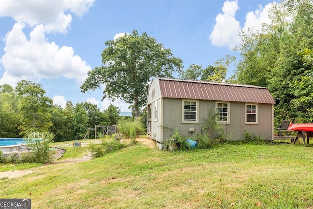 exterior space featuring an outbuilding and a lawn