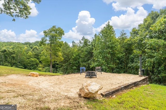 view of property's community featuring a fire pit