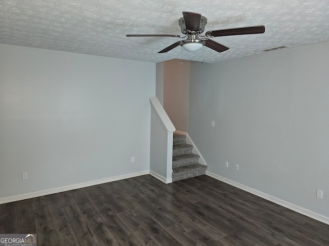 unfurnished room featuring a textured ceiling, ceiling fan, and dark hardwood / wood-style flooring