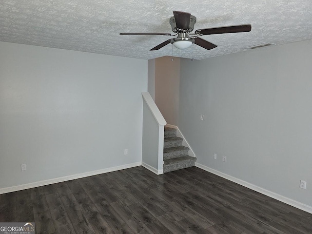 unfurnished living room featuring a textured ceiling, dark wood-type flooring, and ceiling fan