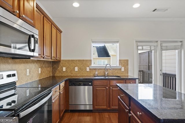 kitchen with crown molding, sink, decorative backsplash, and stainless steel appliances