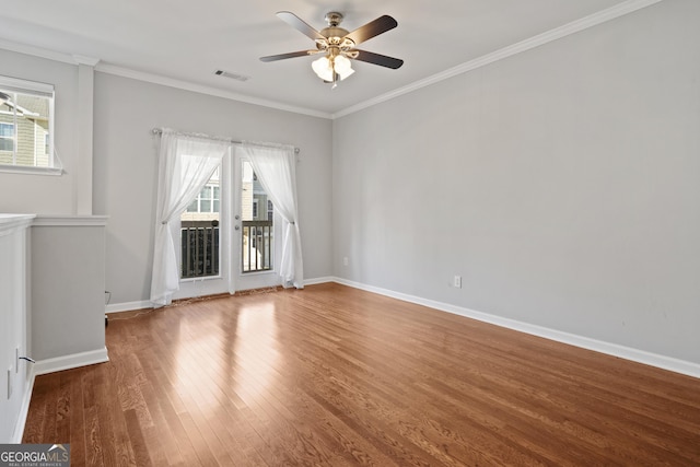 empty room with ceiling fan, wood-type flooring, and ornamental molding