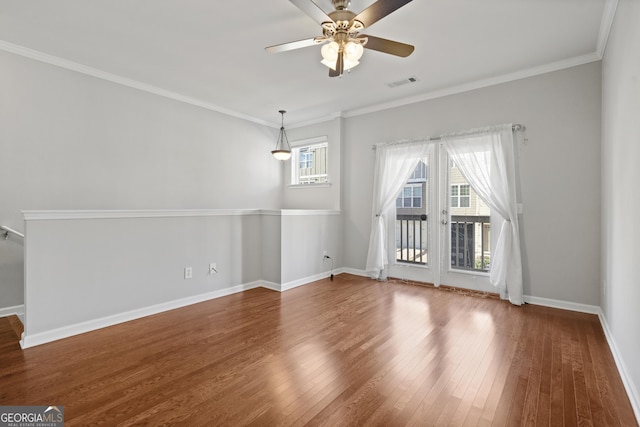 spare room featuring ceiling fan, dark hardwood / wood-style flooring, and crown molding