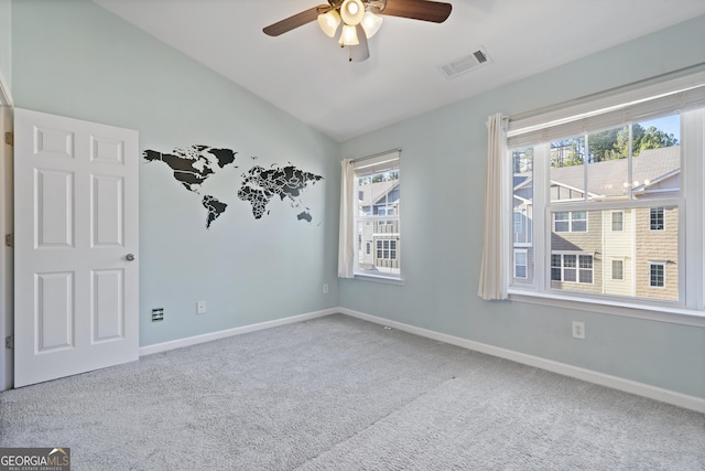 unfurnished room featuring ceiling fan, light colored carpet, and vaulted ceiling