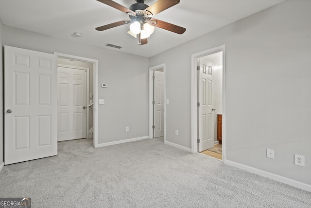 unfurnished bedroom featuring connected bathroom, ceiling fan, and light carpet