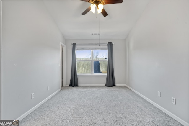 carpeted empty room featuring ceiling fan and vaulted ceiling