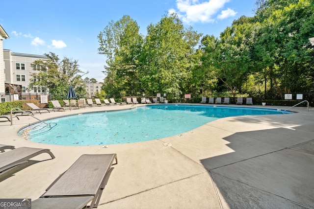 view of swimming pool with a patio area