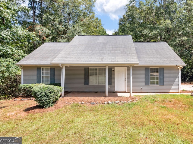 view of front of house featuring a front lawn and covered porch