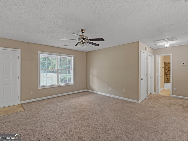 carpeted empty room with a textured ceiling and ceiling fan