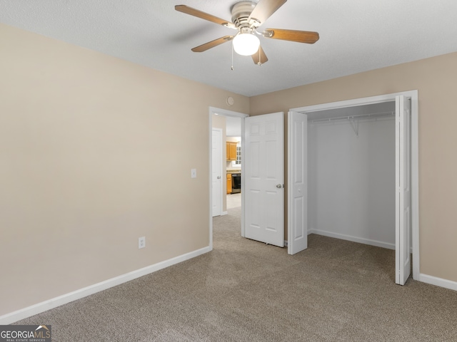 unfurnished bedroom with light colored carpet, ceiling fan, and a closet