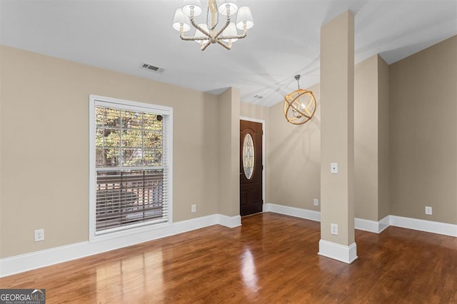 entryway featuring wood-type flooring and a notable chandelier