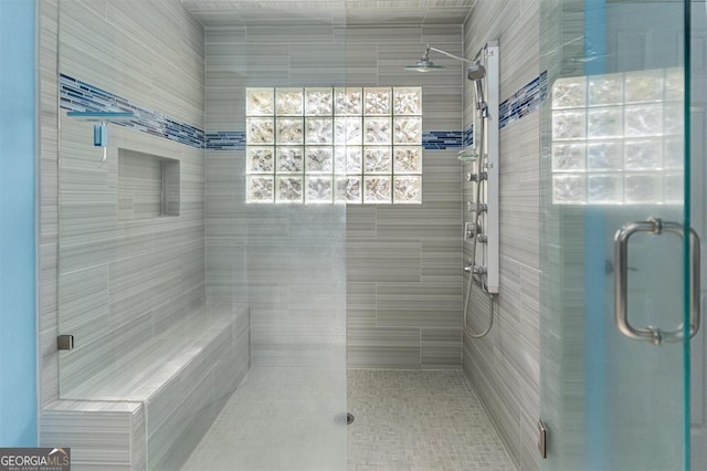 bathroom featuring ceiling fan and walk in shower