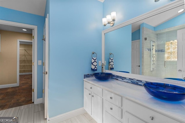 bathroom featuring a shower with door, vanity, and vaulted ceiling