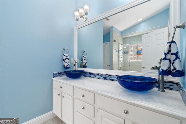 bathroom featuring vanity, vaulted ceiling, walk in shower, and a notable chandelier