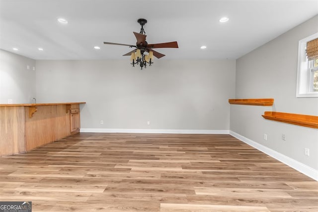 spare room featuring ceiling fan and light hardwood / wood-style flooring