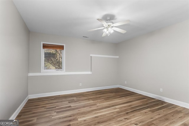 spare room featuring hardwood / wood-style flooring and ceiling fan