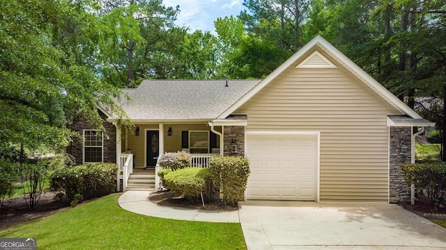 view of front of house with a front lawn, covered porch, and a garage