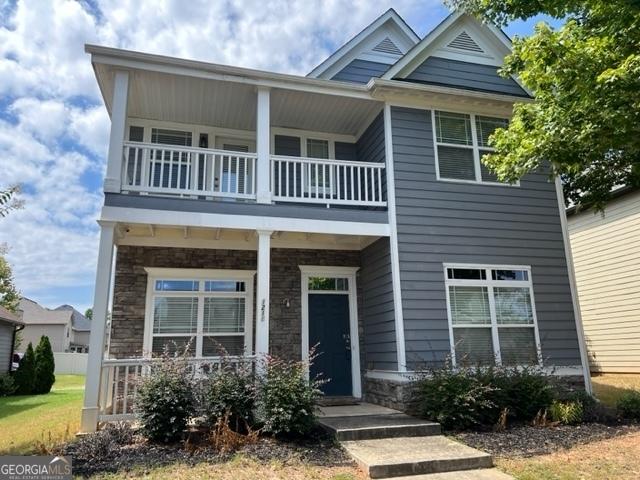 view of front of house featuring a balcony