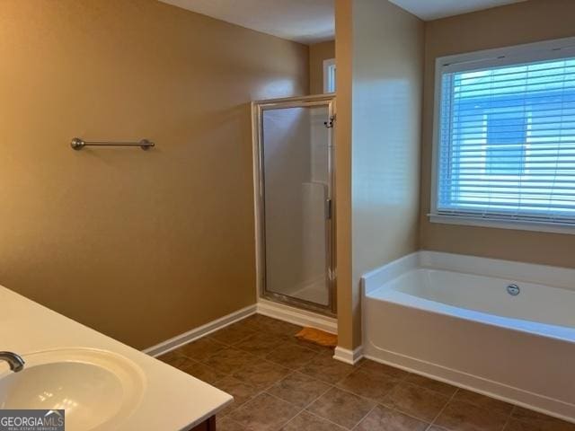 bathroom with vanity, a wealth of natural light, and shower with separate bathtub