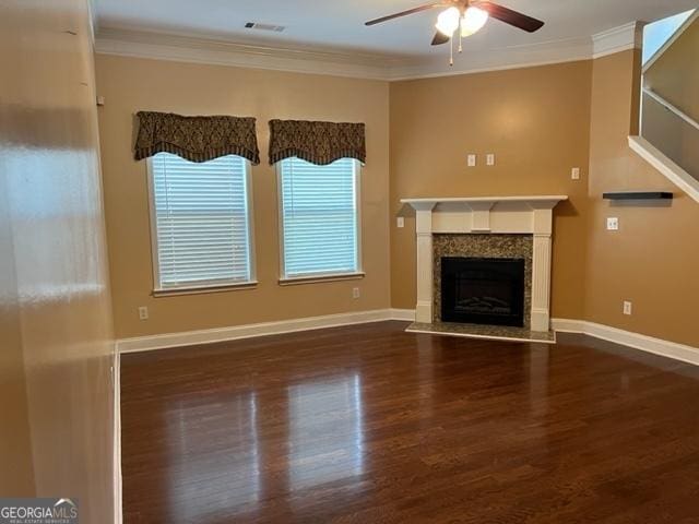 unfurnished living room featuring ceiling fan, dark wood-type flooring, and ornamental molding