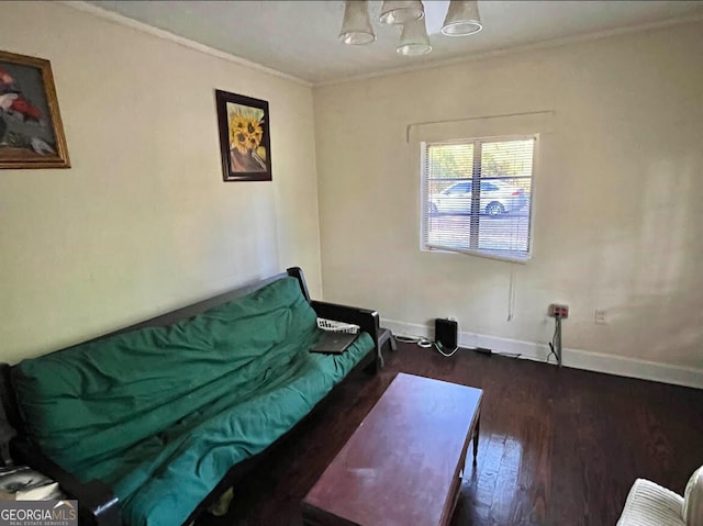 living room featuring crown molding, dark hardwood / wood-style floors, and a chandelier