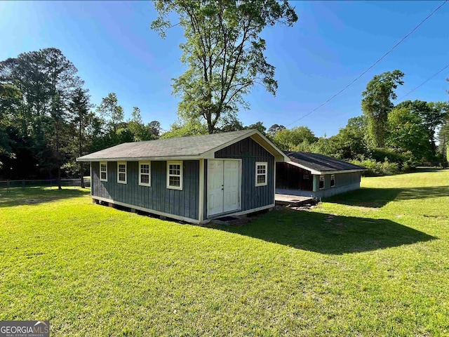 view of side of home featuring a storage unit and a lawn