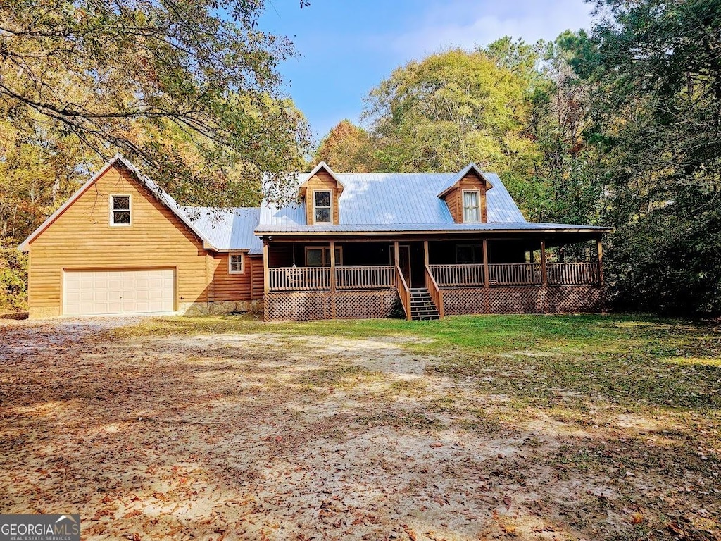 view of front of house featuring a porch and a garage