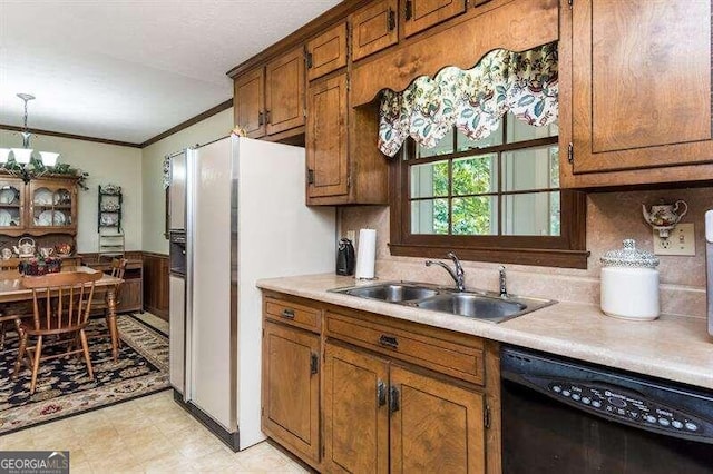 kitchen with dishwasher, crown molding, decorative light fixtures, white refrigerator with ice dispenser, and sink