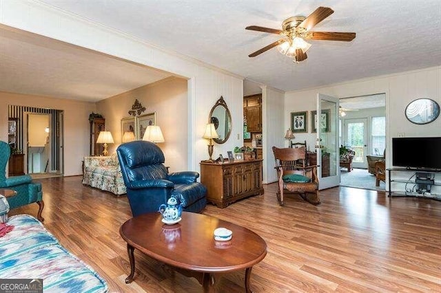 living room featuring french doors, a textured ceiling, hardwood / wood-style floors, and ceiling fan