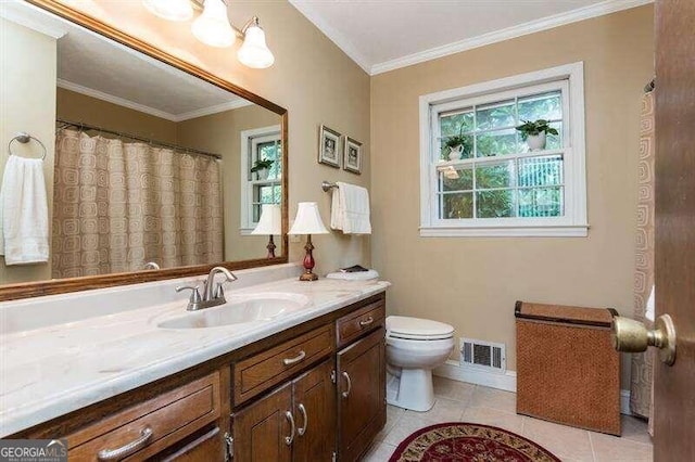 bathroom featuring tile patterned flooring, vanity, toilet, and crown molding