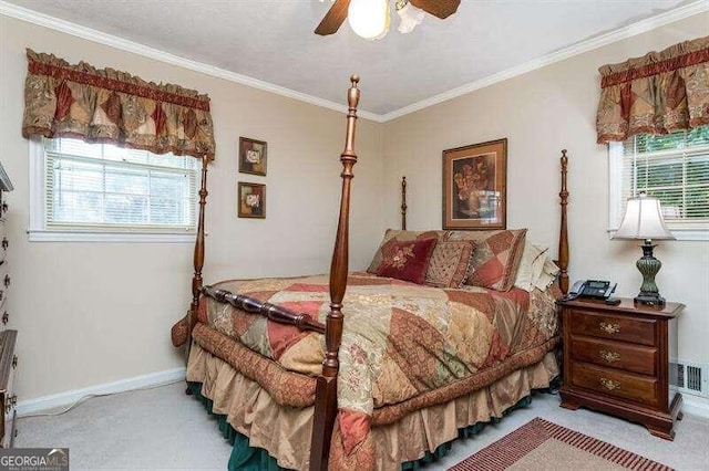 carpeted bedroom featuring crown molding and ceiling fan