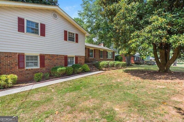 tri-level home with a front lawn