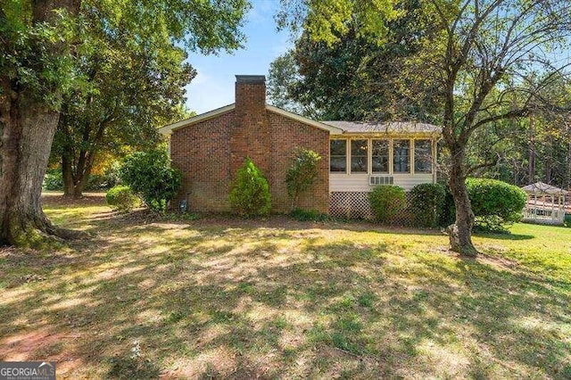 view of side of home featuring a lawn