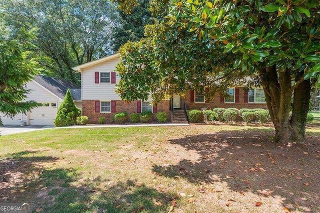 view of front of home with a front yard and a garage