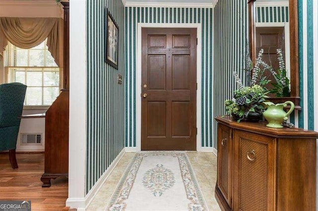 entryway featuring ornamental molding and hardwood / wood-style floors