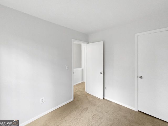 unfurnished bedroom with light carpet