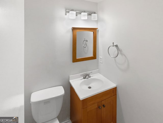 bathroom with toilet and vanity