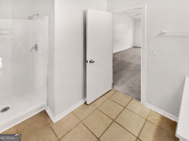 bathroom with tile patterned floors and walk in shower