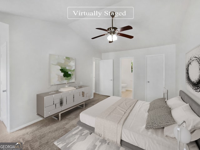 bedroom featuring vaulted ceiling, ensuite bath, carpet floors, and ceiling fan