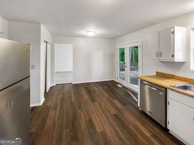 kitchen with white cabinets, stainless steel appliances, dark hardwood / wood-style flooring, and sink