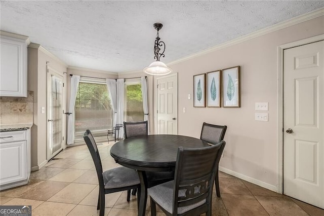 dining space featuring a textured ceiling, light tile patterned floors, baseboards, and crown molding