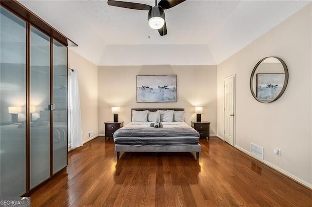 bedroom featuring visible vents, dark wood finished floors, and baseboards