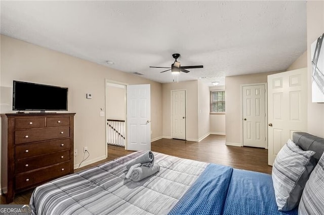 bedroom featuring ceiling fan, baseboards, and wood finished floors