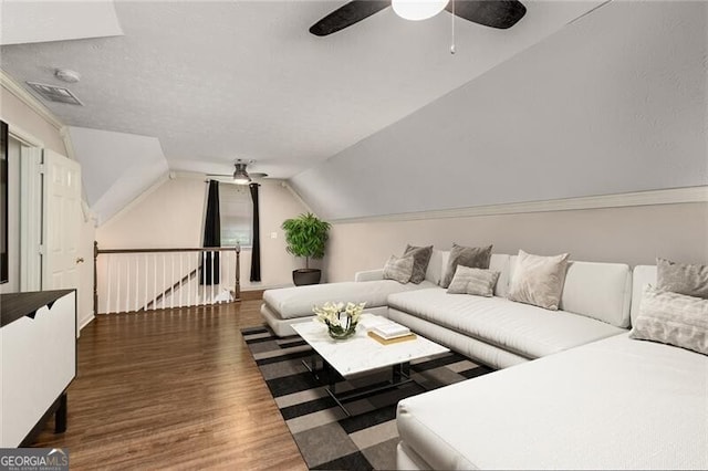 living area featuring vaulted ceiling, ceiling fan, and wood finished floors